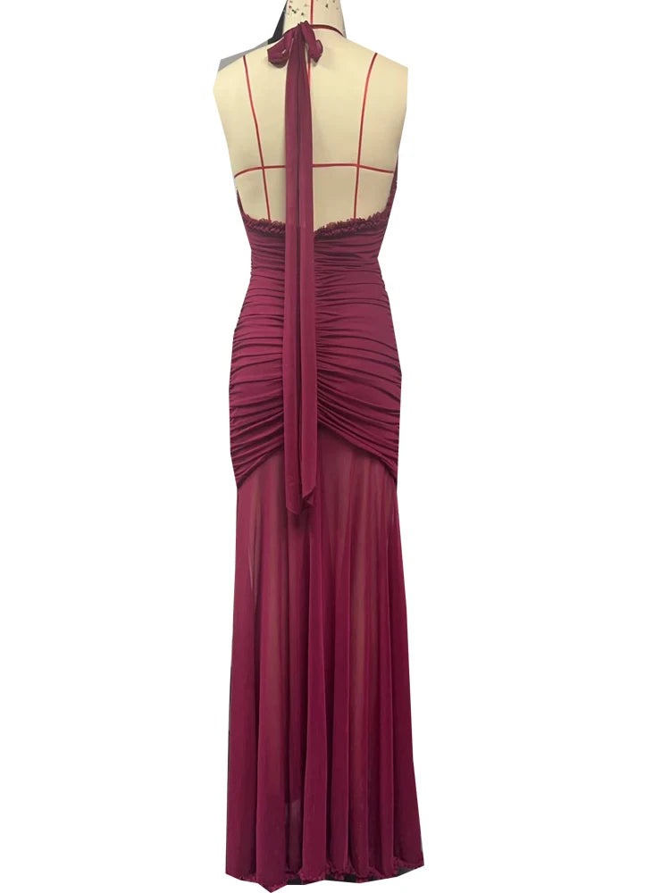 Magenta evening gown on a mannequin with a white background