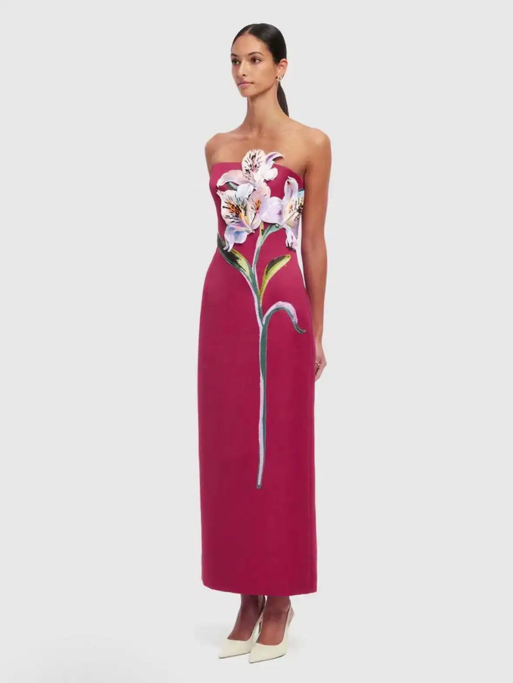 Strapless column maxi dress with floral appliqué in red.