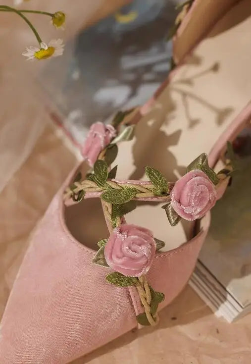 Close-up of pink rose and green vine detail on kitten heel pump