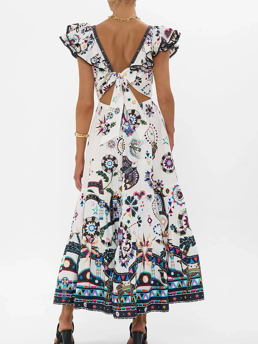 Woman wearing a colorful patterned dress with a back tie