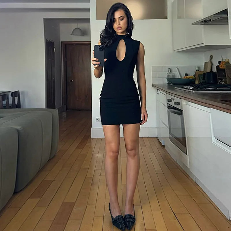 Woman taking a mirror selfie in a modern kitchen and living room.