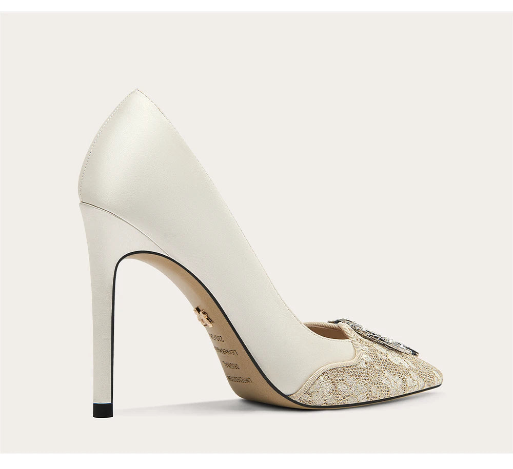 White high-heeled shoe with a decorative sole on a light gray background