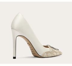 White high-heeled shoe with a decorative sole on a light gray background