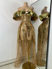 Gold sequin dress on a mannequin with a mirror reflection.