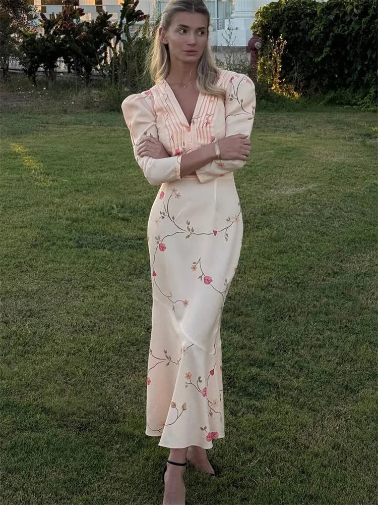 Woman in a floral dress standing on grass