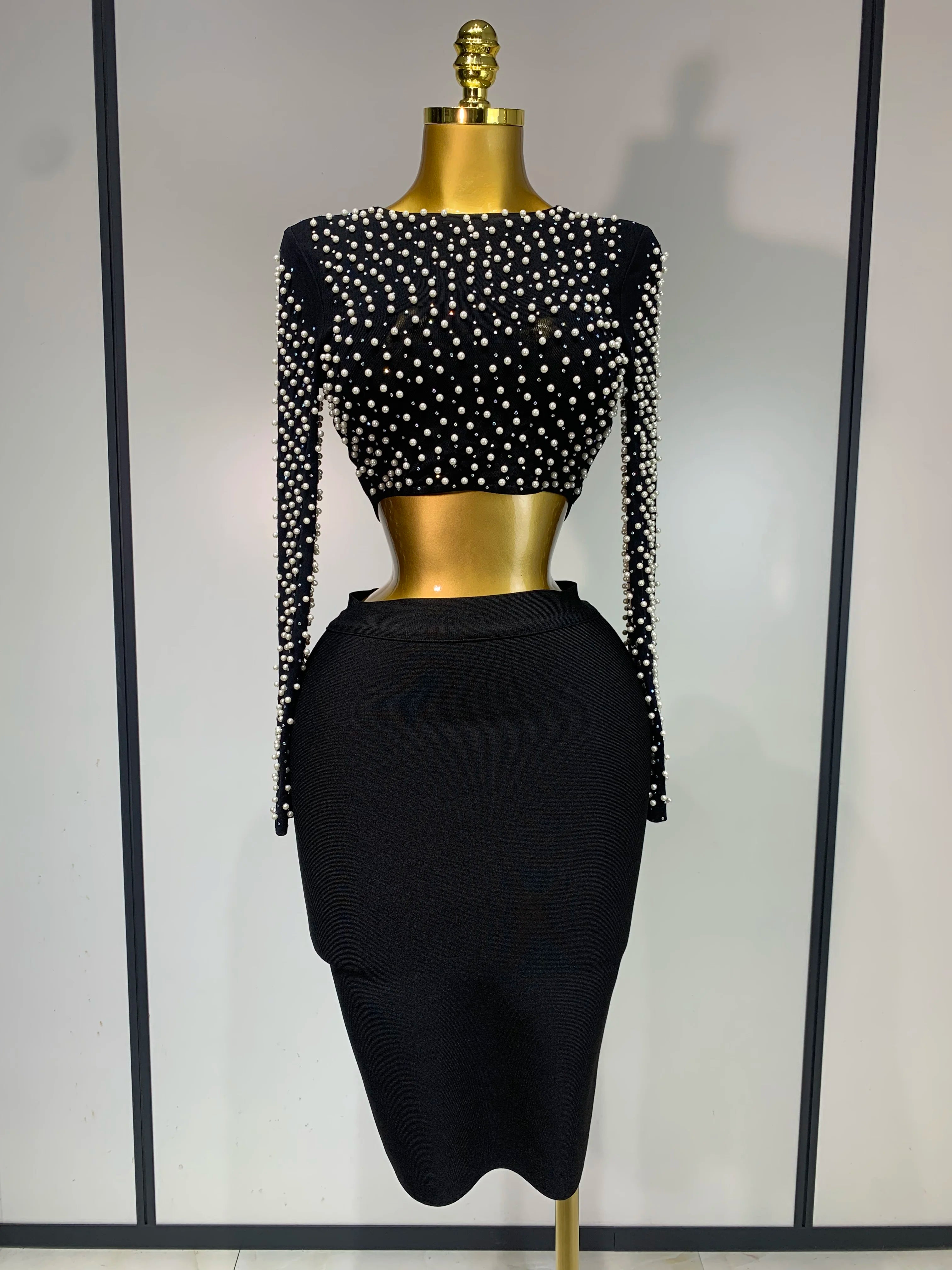 Black beaded top and skirt set on a mannequin against a neutral background