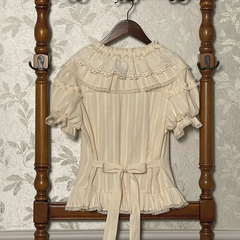 Back view of cream lace collar blouse with bow detail and short puff sleeves
