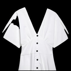 White blouse with black buttons on a light gray background