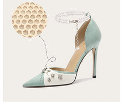 Light blue and white high-heeled shoe with decorative elements on a light gray background