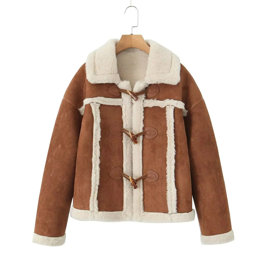 Brown suede jacket with white fur lining on a hanger against a white background