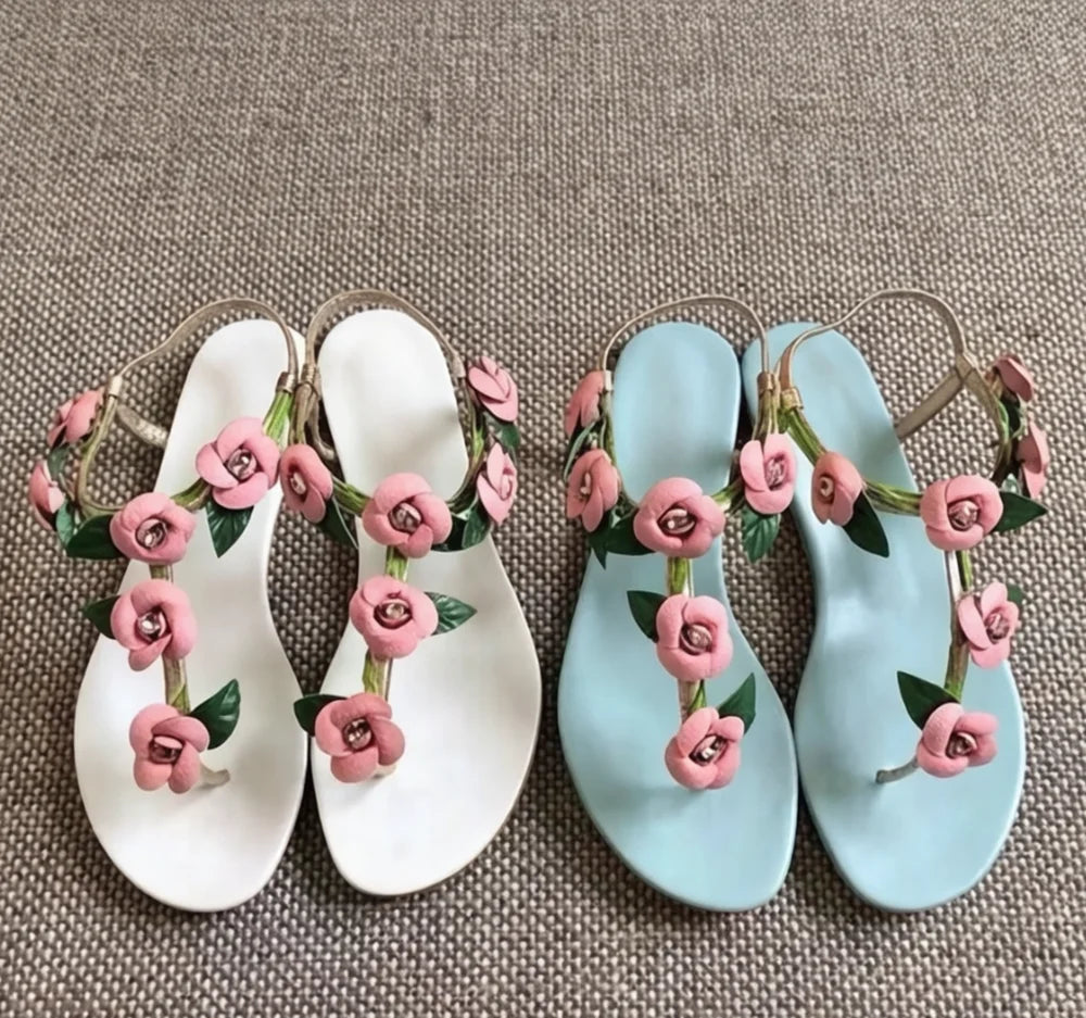 Pair of light blue floral thong slingback flat sandals