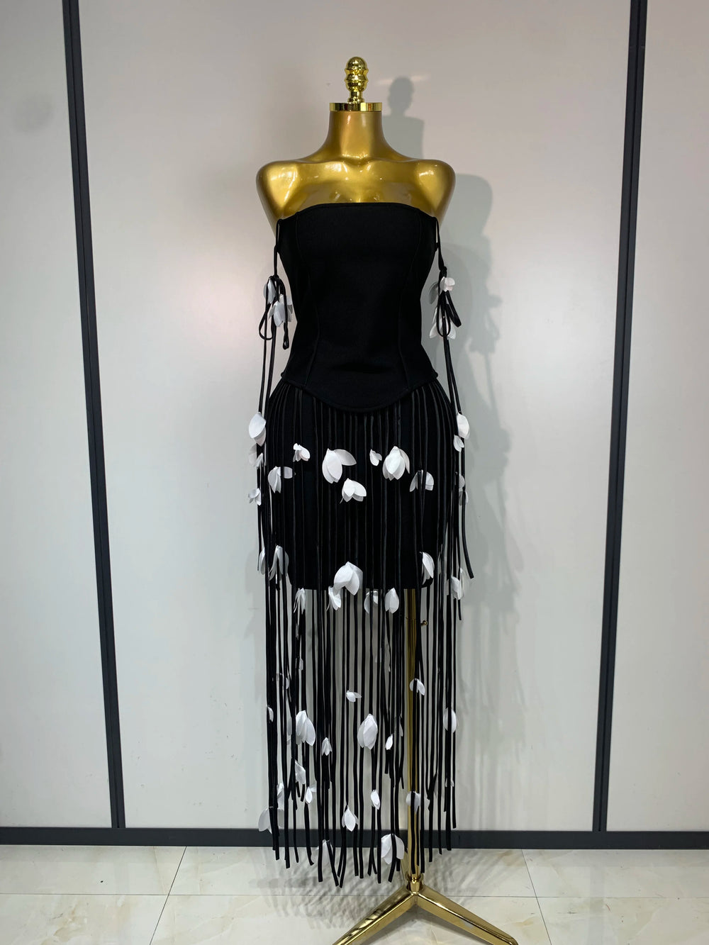 Black strapless bodycon mini dress with tassel trim