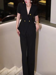 Person wearing a black suit with gold buttons in an indoor setting