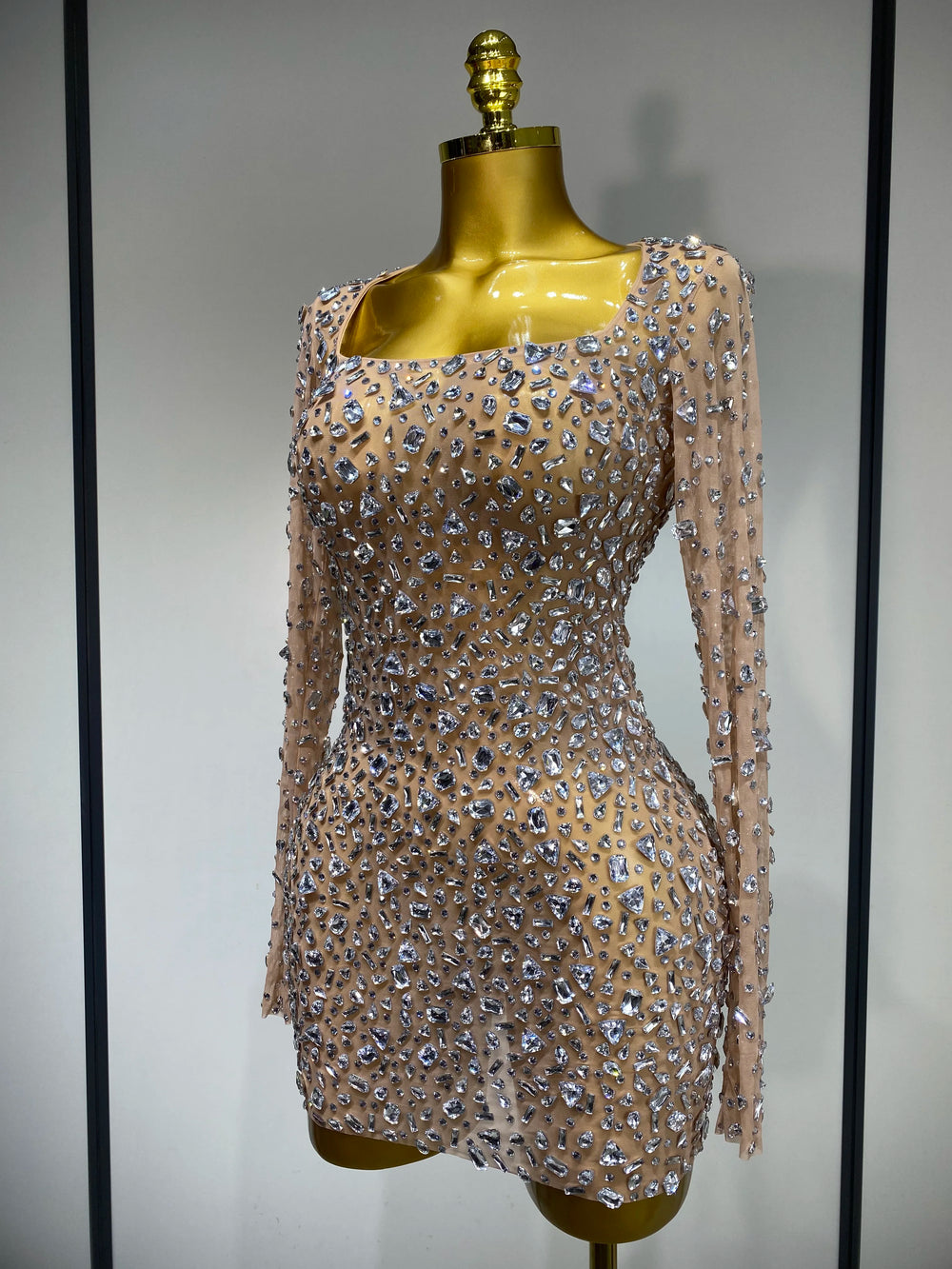 Close-up of khaki full sleeve crystal embellished mini dress
