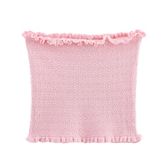 Pink textured pillow with ruffled edge on a white background