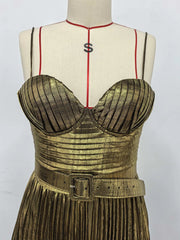 Gold dress on a mannequin with a white background