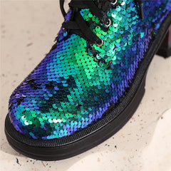 Shoe with blue and green sequin pattern on a light background