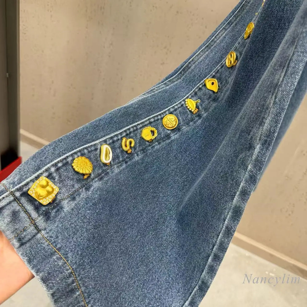 Close-up of denim patchwork button detail on pants
