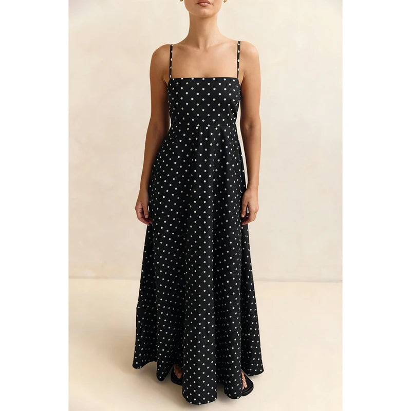 Black polka dot dress on a neutral background