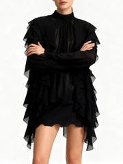 Black ruffled dress worn by a person on a white background