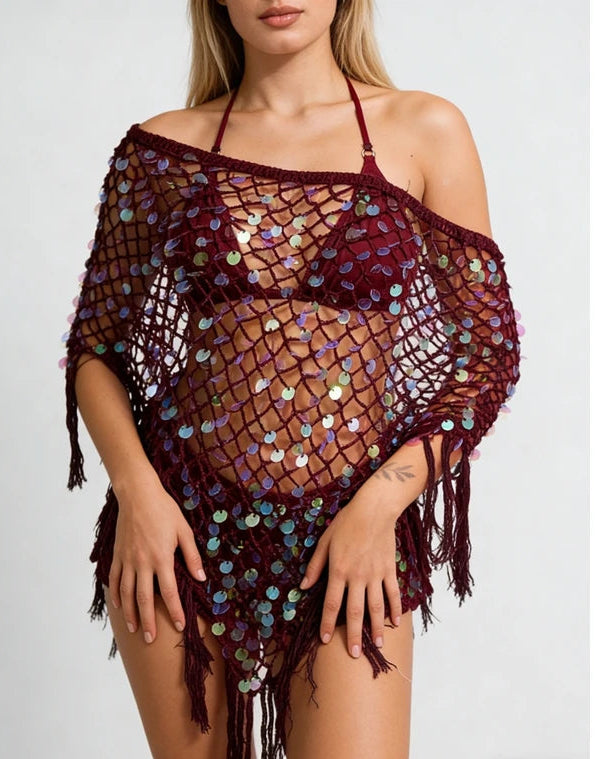 Burgundy sequin knit poncho with fringe hem worn by a model.