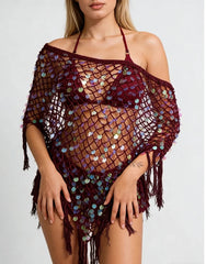 Burgundy sequin knit poncho with fringe hem worn by a model.