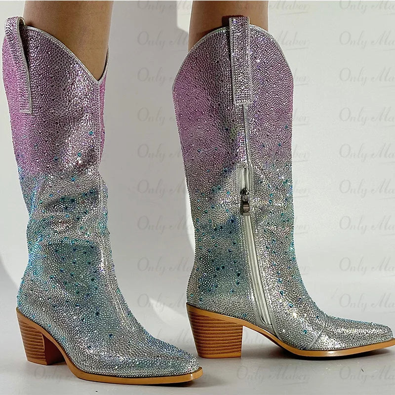 Silver and purple glittery cowboy boots on a white background