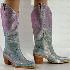 Silver and purple glittery cowboy boots on a white background