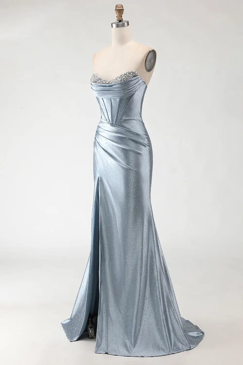 Silver evening gown on a mannequin against a white background