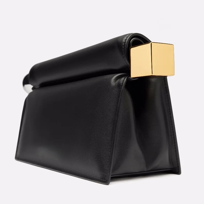 Black clutch bag with a gold clasp on a white background