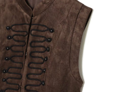 Close-up of decorative knot button detail on vest top