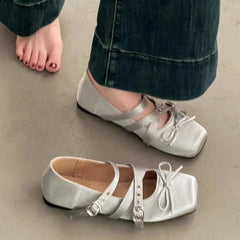 Square toe ballet flat in silver with cross straps and buckle detail