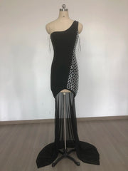 Black one-shoulder dress with sheer overlay on a mannequin against a white background