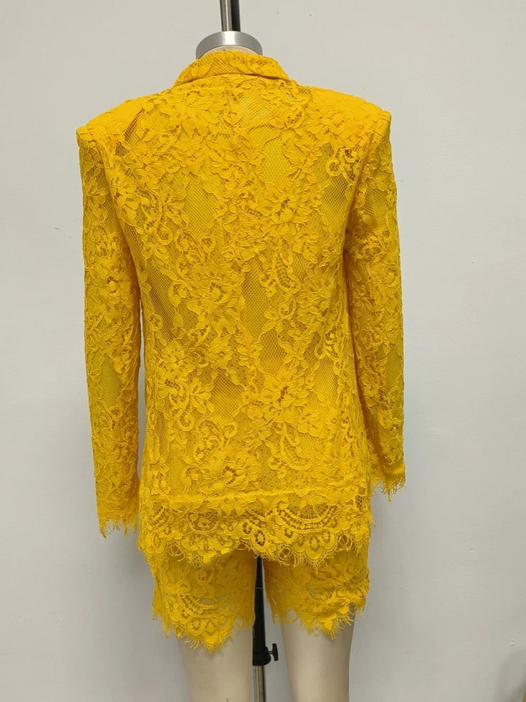 Yellow lace outfit on a mannequin against a plain background