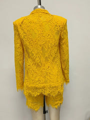 Yellow lace outfit on a mannequin against a plain background