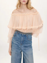 Off-shoulder floral print blouse with ruffled trim and tiered sleeves.