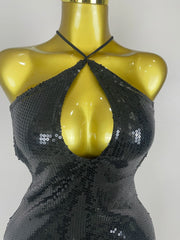 Black sequin top on a mannequin against a plain background
