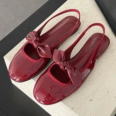 Red patent bow slingback pumps with round toe