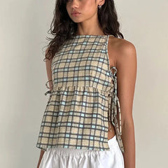 Woman wearing a plaid top with a neutral background