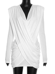 White draped dress on a mannequin against a white background