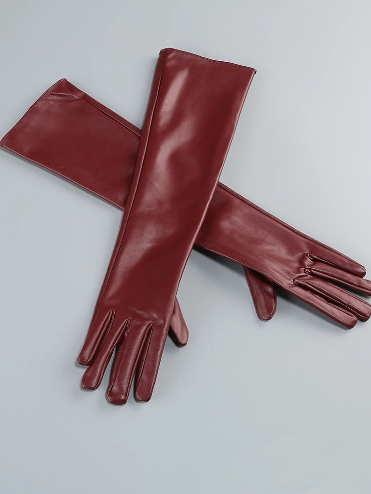 Pair of red leather gloves on a light gray background