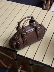 Brown leather handbag on a wooden table