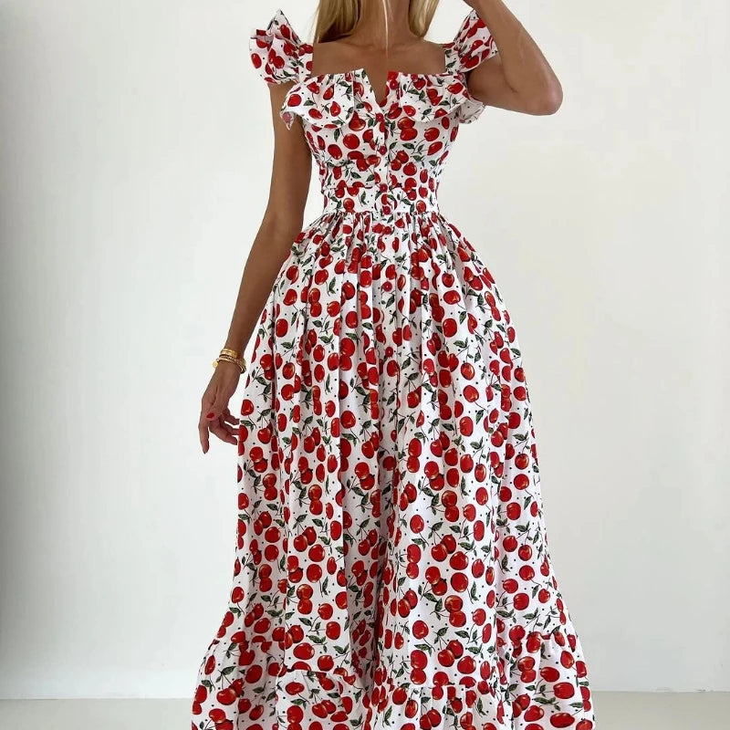 Woman wearing a red and white floral dress against a plain background