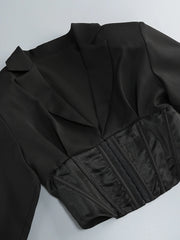 Black jacket with a fitted waist on a light gray background