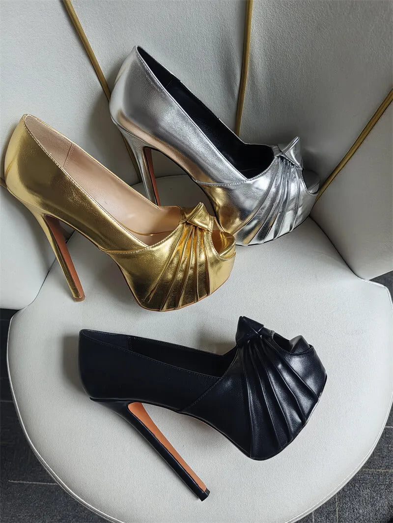 Gold and silver platform stiletto peep toe heels arranged on a chair.