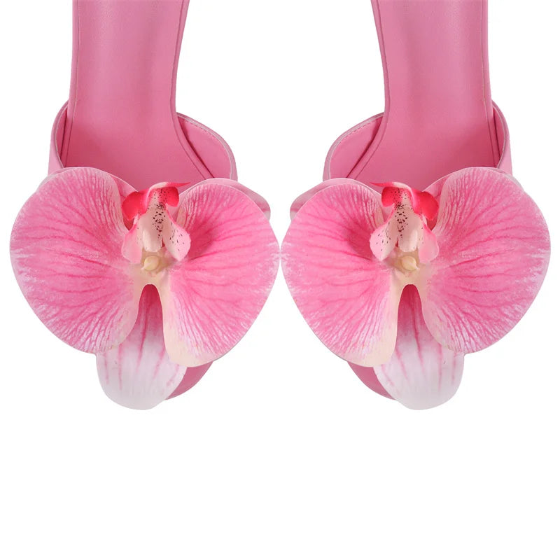 Close-up of floral accent on pink platform stiletto sandals