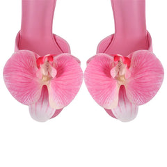 Close-up of floral accent on pink platform stiletto sandals