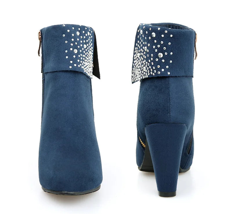 Blue ankle boots with rhinestone embellishments on a white background