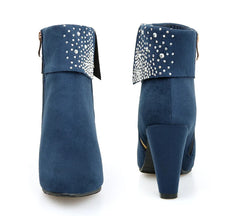 Blue ankle boots with rhinestone embellishments on a white background