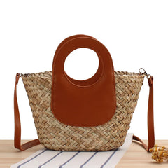 Woven bag with brown leather top section on a white background